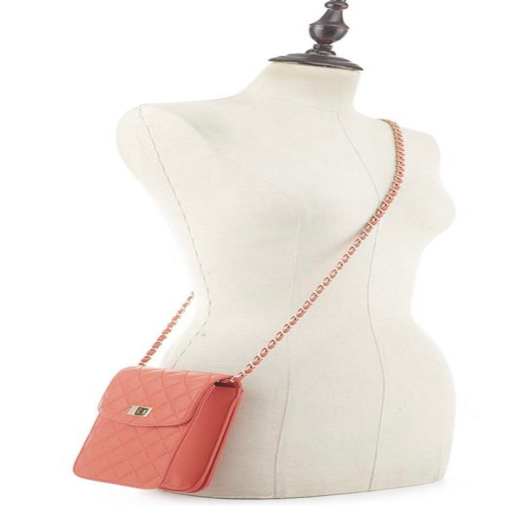 Coral quilted handbag on mannequin